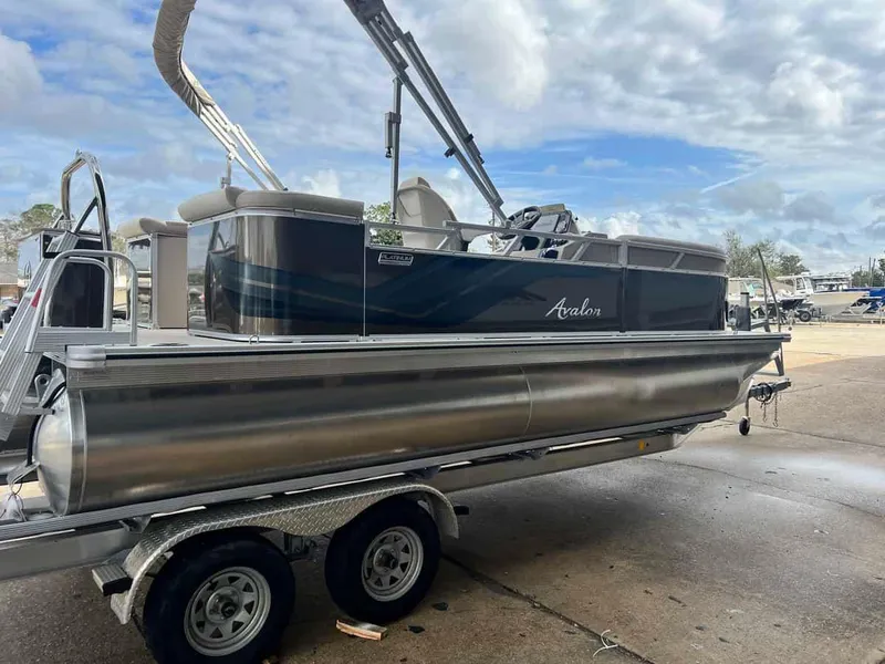 Slide: The Image of 2023 Avalon 2185 Venture CR2 pontoon boat on trailer, outdoor setting. - 4