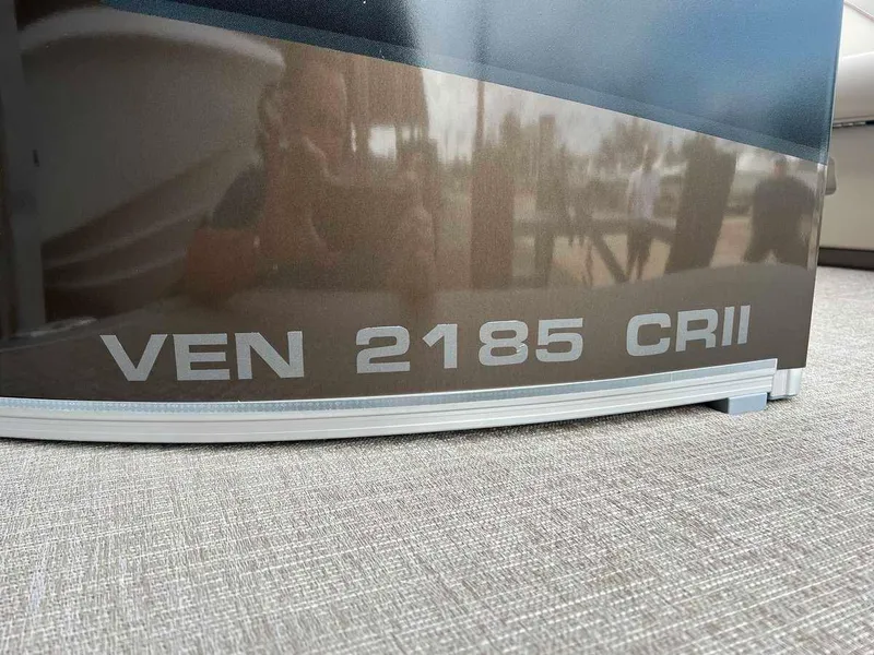 Slide: The Image of Close-up of 2023 Avalon 2185 Venture CR2 model name on boat exterior. - 5