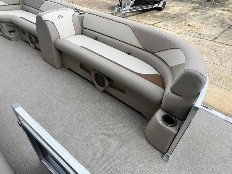 Slide: The Image of 2023 Avalon 2185 Venture CR2 boat interior with beige seating and cup holders. - 6