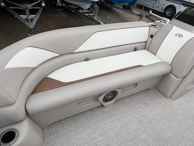 Slide: The Image of 2023 Avalon 2185 Venture CR2 boat interior with beige and white cushioned seating. - 7