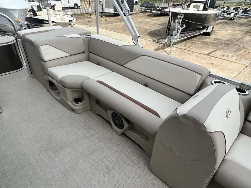 Slide: The Image of 2023 Avalon 2185 Venture CR2 boat interior with beige seating and cup holders. - 8