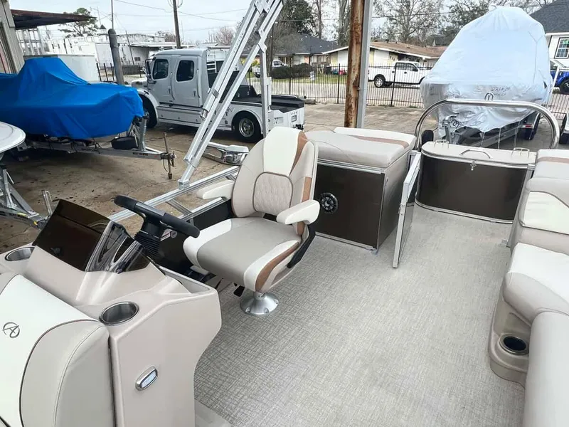 Slide: The Image of 2023 Avalon 2185 Venture CR2 pontoon boat interior with captain's chair and control console. - 9