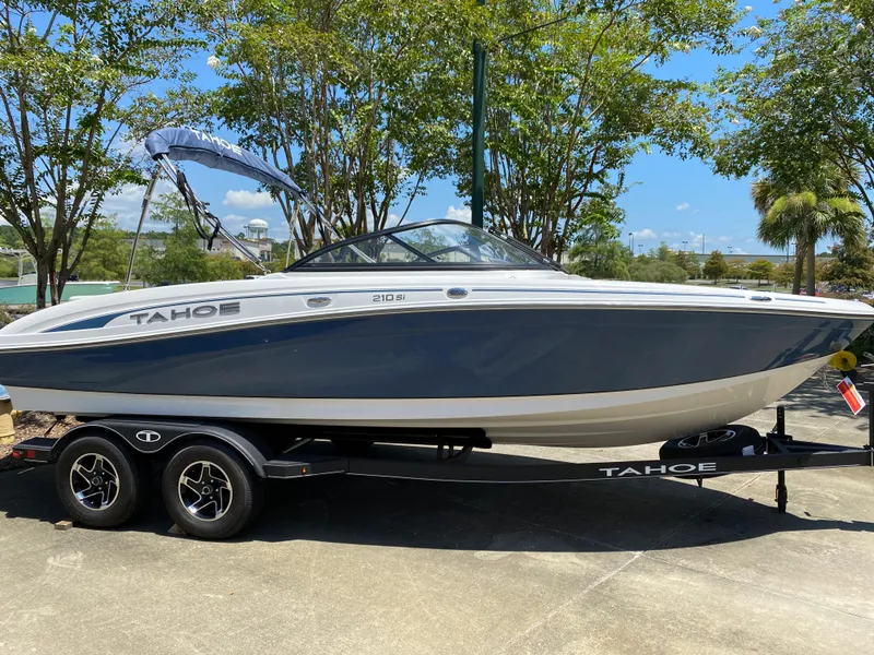 The Image of 2023 Tahoe 210 Si boat on trailer, parked outdoors under clear sky. - 0
