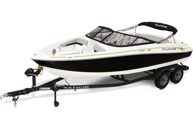 Slide: The Image of 2023 Tahoe 210 Si boat on trailer, parked on grass under cloudy sky. - 2