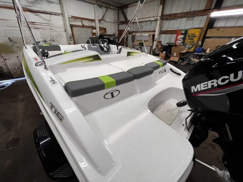 Slide: The Image of 2023 Tahoe T16 boat with Mercury outboard motor in a storage facility. - 7