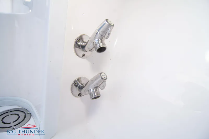Slide: The Image of Close-up of 2023 Fountain 38 SC boat's chrome water faucets. - 21