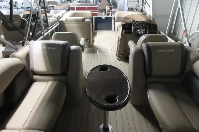 Slide: The Image of 2023 Sylvan Mirage 8524 LZ pontoon boat interior with luxurious seating and steering console. - 10
