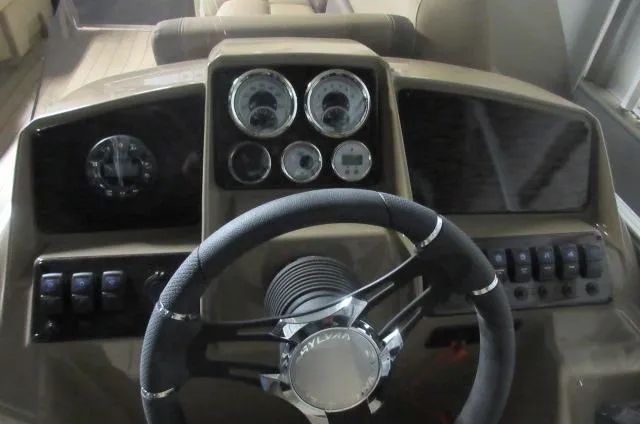 Slide: The Image of 2023 Sylvan Mirage 8524 LZ boat dashboard with steering wheel and instrument panel. - 5