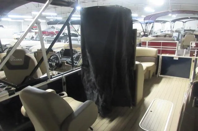Slide: The Image of 2023 Sylvan Mirage 8524 LZ pontoon boat interior with seating and steering console. - 6