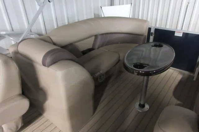 Slide: The Image of 2023 Sylvan Mirage 8524 LZ boat interior with beige seating and a black table. - 7