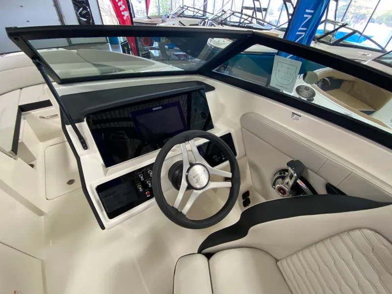 Slide: The Image of 2023 Sea Ray SPX 230 OB boat cockpit with steering wheel and control panel. - 3