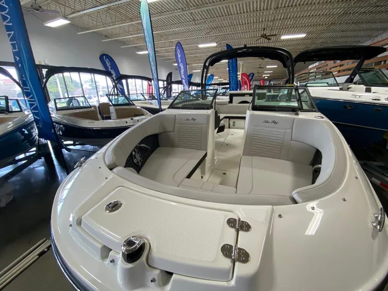 Slide: The Image of 2023 Sea Ray SPX 230 OB boat interior at a showroom. - 4