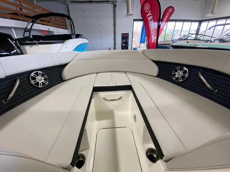 Slide: The Image of 2023 Sea Ray SPX 230 OB boat interior with white seating and speakers. - 5