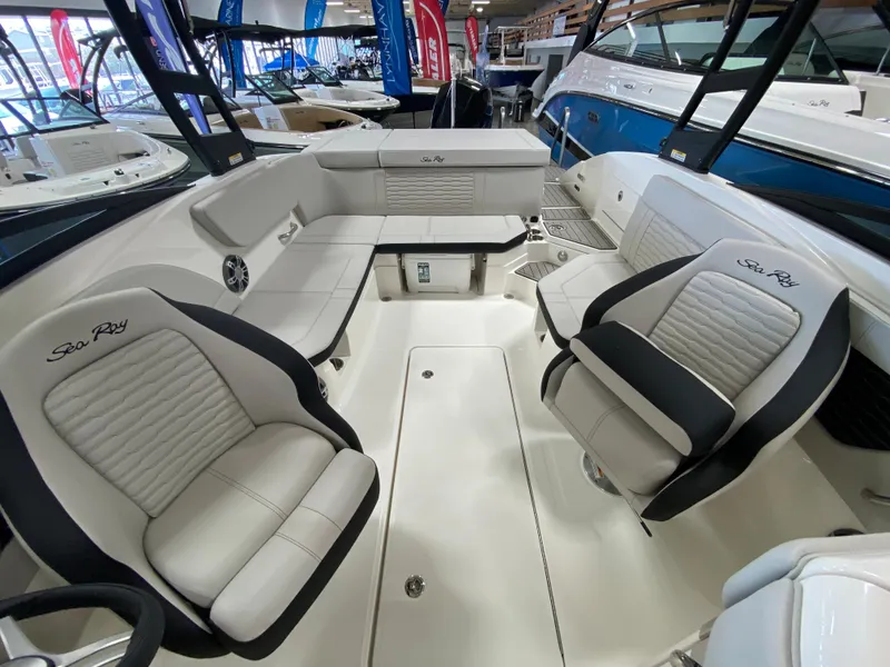 Slide: The Image of 2023 Sea Ray SPX 230 OB boat interior with white and black seating. - 6