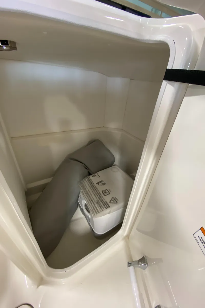 Slide: The Image of Storage compartment in 2023 Sea Ray SPX 230 OB boat with cushion and equipment. - 8