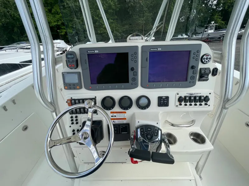 Slide: The Image of 2009 Hydra-Sports 2900 CC boat dashboard with dual Raymarine displays and steering wheel. - 1