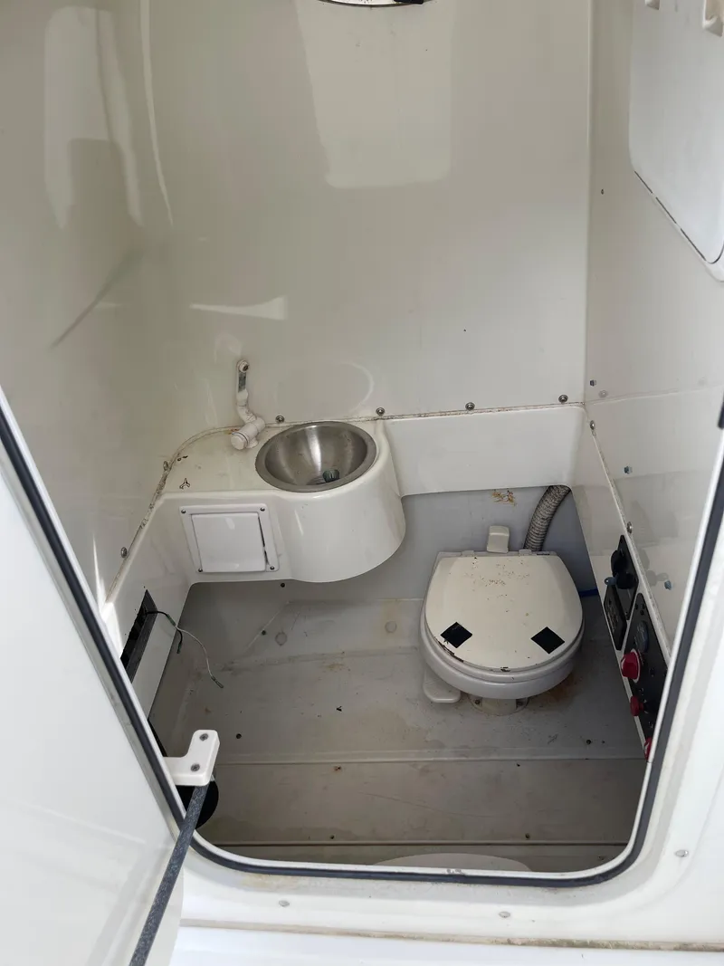 Slide: The Image of 2009 Hydra-Sports 2900 CC boat interior bathroom with toilet and sink. - 11