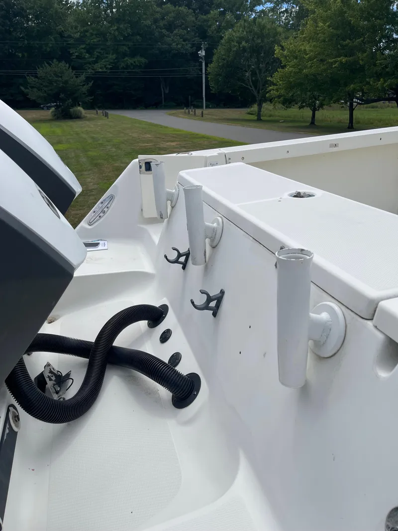 Slide: The Image of 2009 Hydra-Sports 2900 CC boat deck with rod holders and engine hoses. - 14