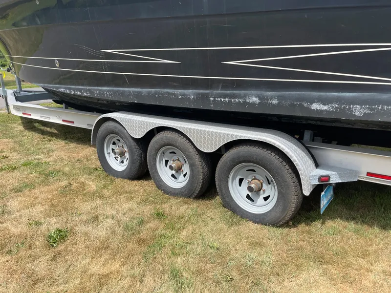 Slide: The Image of 2009 Hydra-Sports 2900 CC boat on a triple-axle trailer. - 2