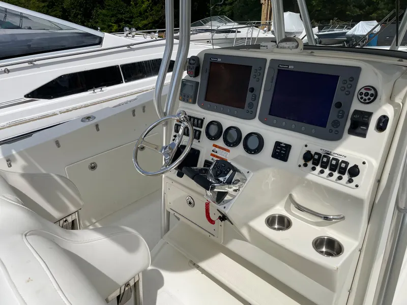 Slide: The Image of 2009 Hydra-Sports 2900 CC boat cockpit with dual navigation screens and steering wheel. - 22