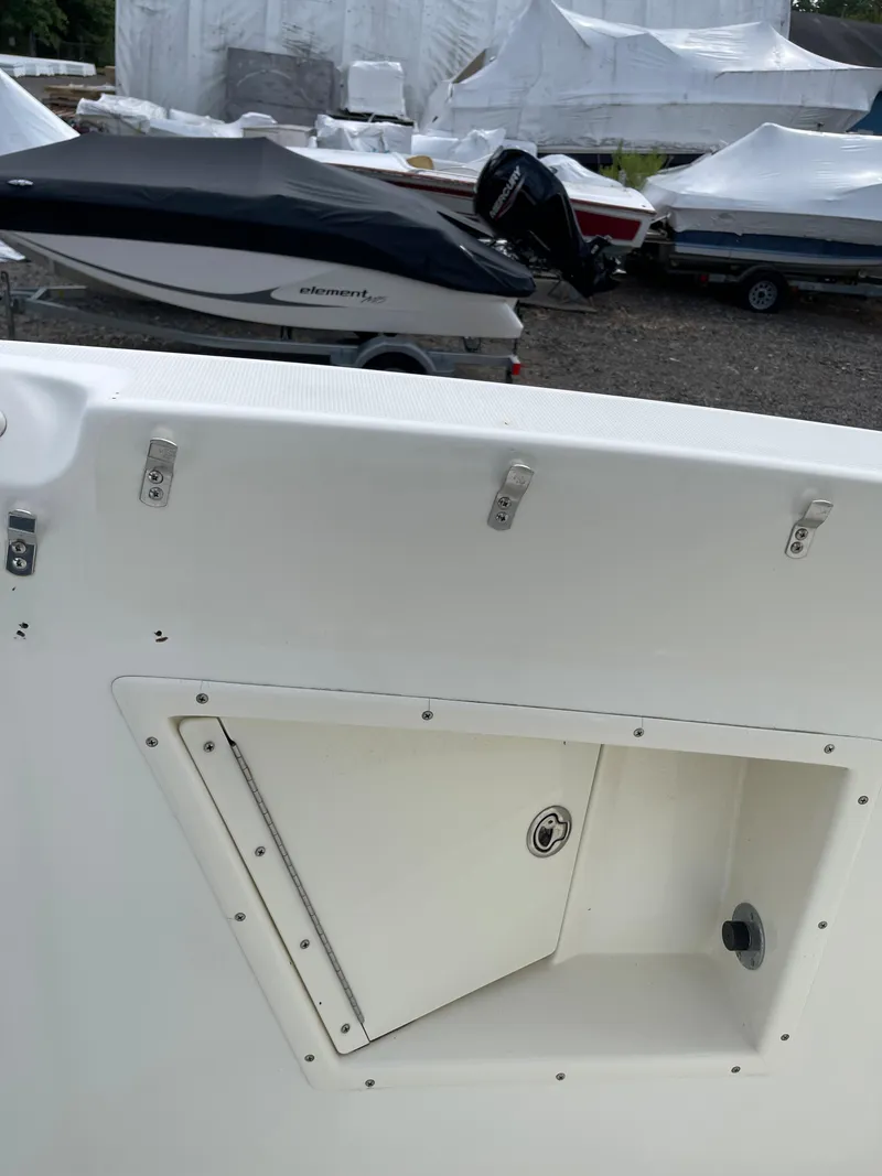 Slide: The Image of 2009 Hydra-Sports 2900 CC boat with storage compartment, docked near other covered boats. - 32
