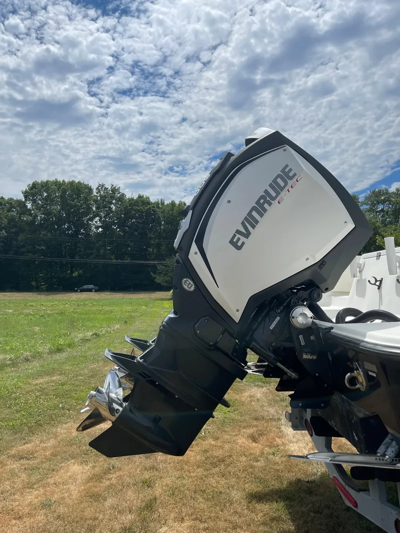 Slide: The Image of 2009 Hydra-Sports 2900 CC with Evinrude outboard motor in a grassy field. - 4