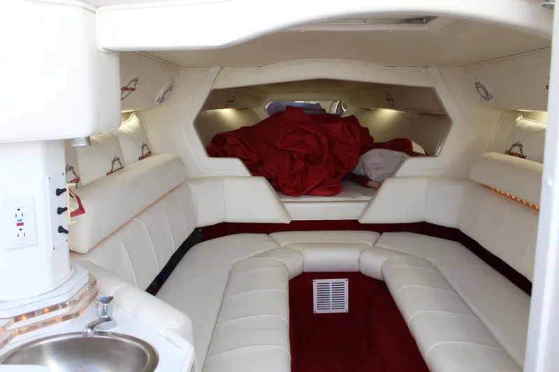 Slide: The Image of The interior of a 2007 Fountain 42 Lightning features a luxurious cabin with white upholstery and red accents. - 39