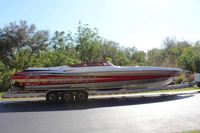 Slide: The Image of A 2007 Fountain 42 Lightning boat on a trailer, surrounded by trees. - 14
