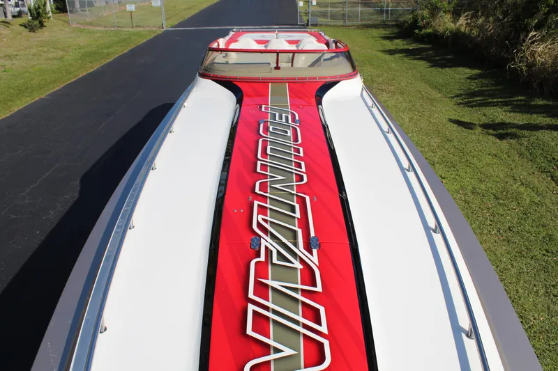 Slide: The Image of A 2007 Fountain 42 Lightning boat with striking red design and lettering on the deck. - 17