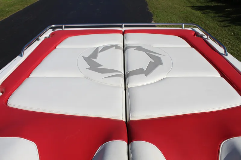 Slide: The Image of The image shows a boat's padded sun deck with red and white upholstery. - 24
