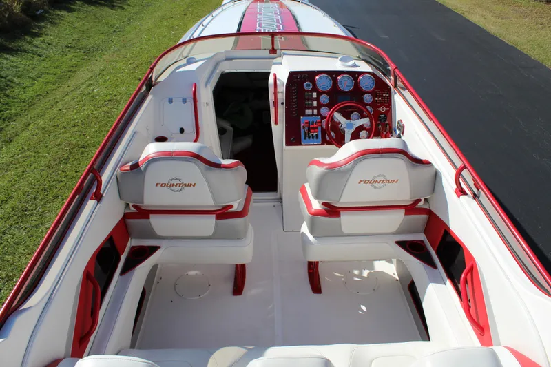 Slide: The Image of The image shows the cockpit of a 2007 Fountain 42 Lightning boat with red and white seating. - 28