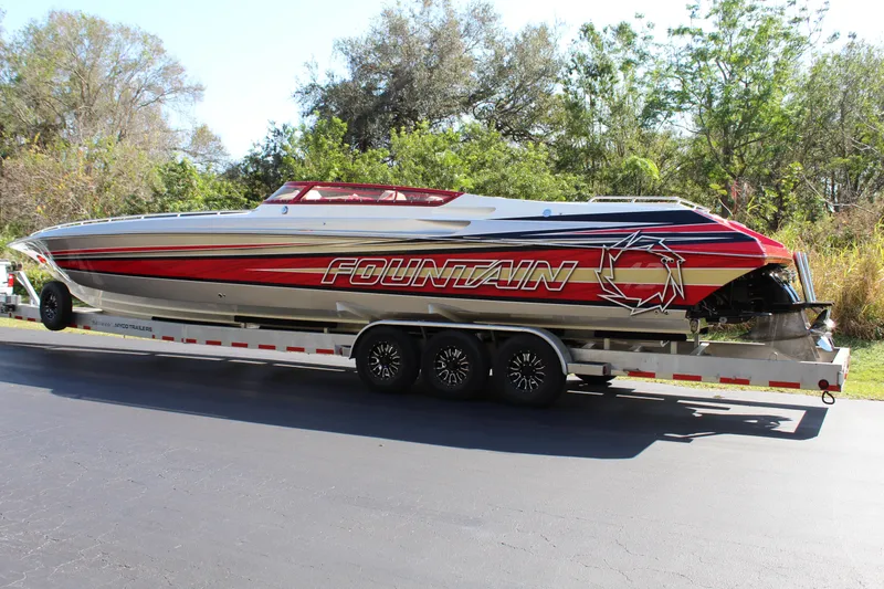 Slide: The Image of A 2007 Fountain 42 Lightning on a trailer, featuring bold red and black design with logo. - 5