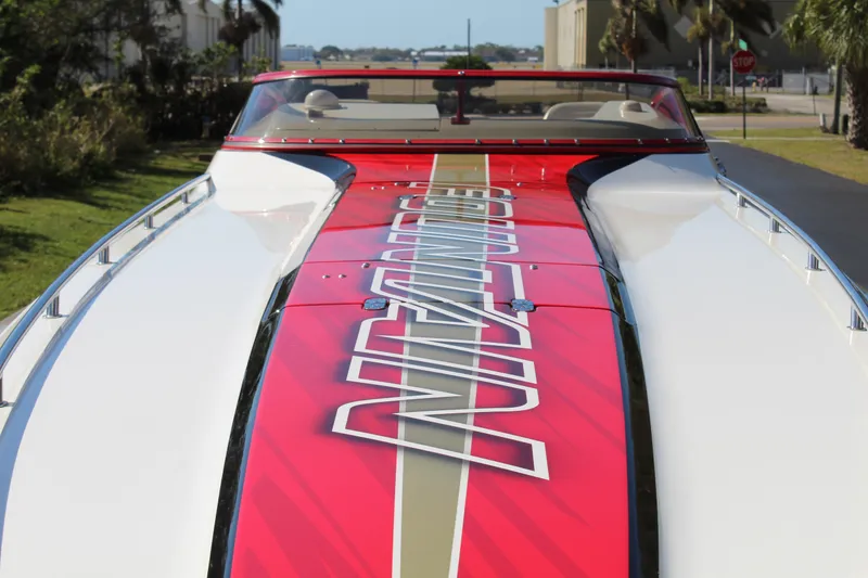 Slide: The Image of A 2007 Fountain 42 Lightning with a striking red stripe and lettering on the deck. - 19