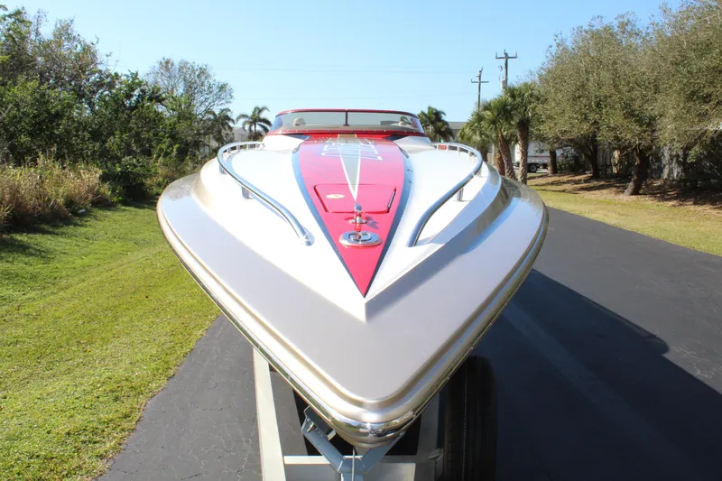 Slide: The Image of A 2007 Fountain 42 Lightning boat on a trailer, featuring a distinctive red stripe on the deck. - 16