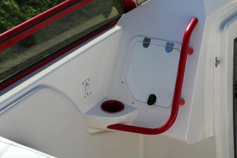 Slide: The Image of Close-up of a white boat with red accents and a cup holder. - 33