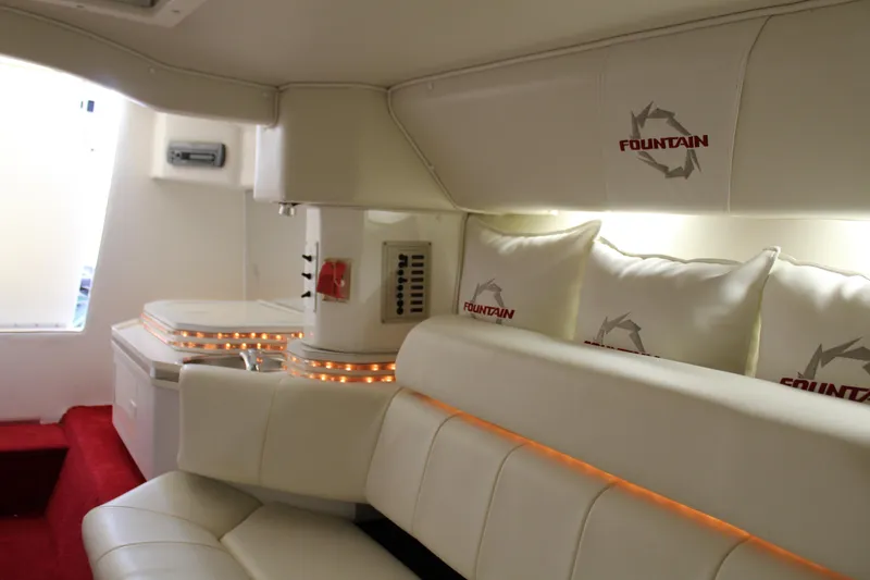 Slide: The Image of The interior of a 2007 Fountain 42 Lightning with white leather seating and red carpeting. - 45