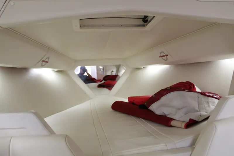 Slide: The Image of Interior of a 2007 Fountain 42 Lightning with white upholstery and red blankets. - 40