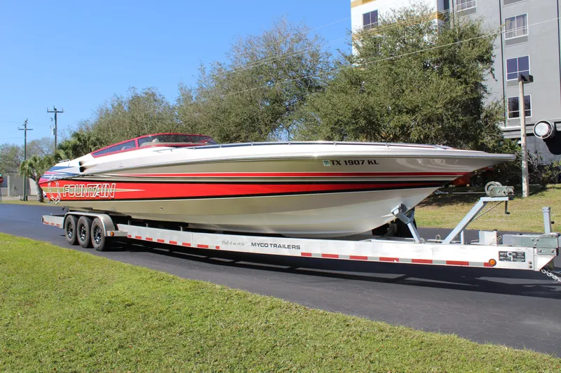 Slide: The Image of A 2007 Fountain 42 Lightning boat on a trailer, featuring a red and white stripe design. - 3