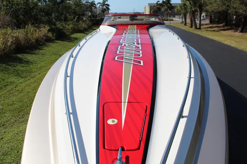 Slide: The Image of A 2007 Fountain 42 Lightning with a striking red stripe on the deck, parked on a road. - 18