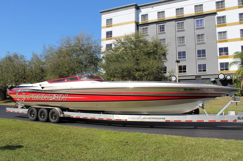 Slide: The Image of A 2007 Fountain 42 Lightning boat on a trailer in front of a building. - 2