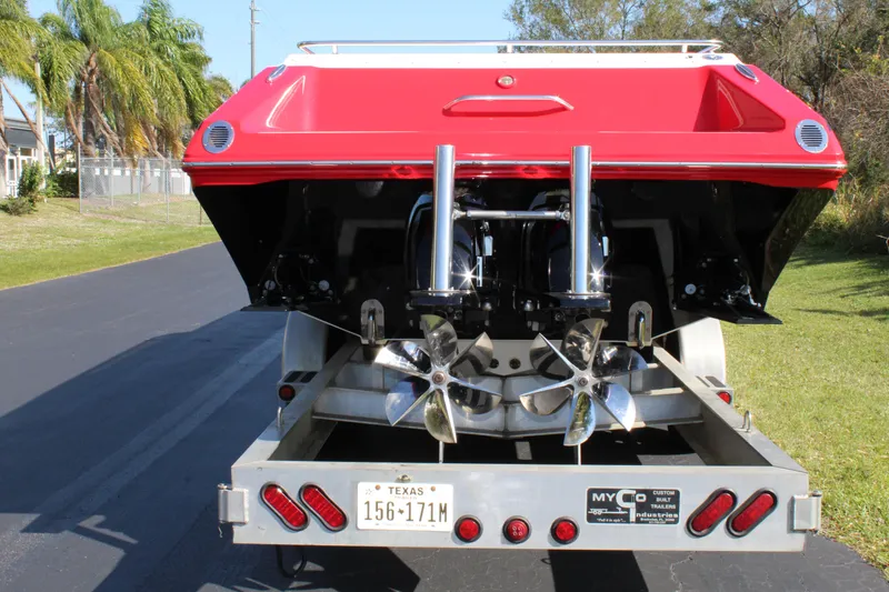 Slide: The Image of Red stern of a 2007 Fountain 42 Lightning boat with dual engines and propellers on a trailer. - 9