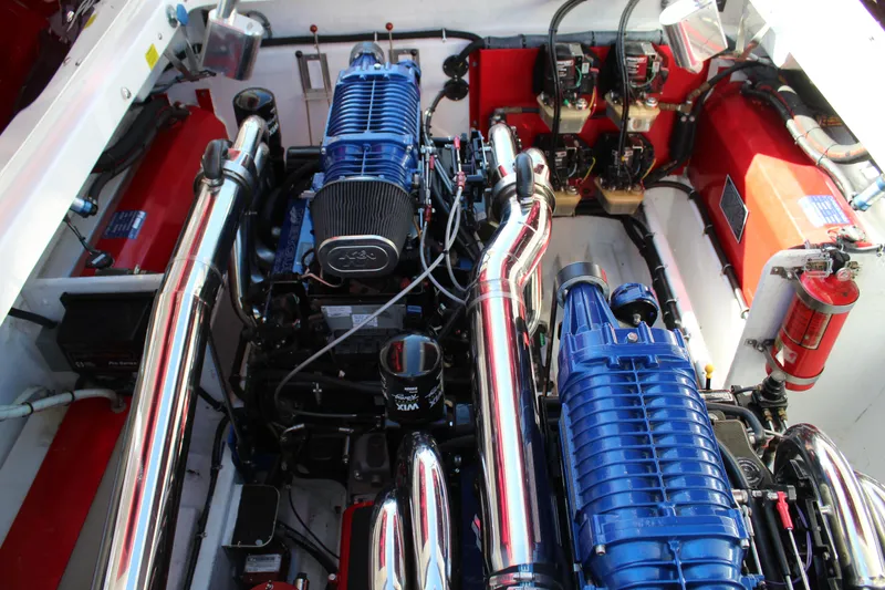 Slide: The Image of Engine compartment of a 2007 Fountain 42 Lightning with blue engines and shiny exhaust pipes. - 34