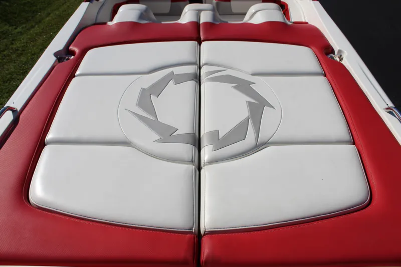 Slide: The Image of The image shows the padded aft deck of a 2007 Fountain 42 Lightning boat with red and white design. - 23