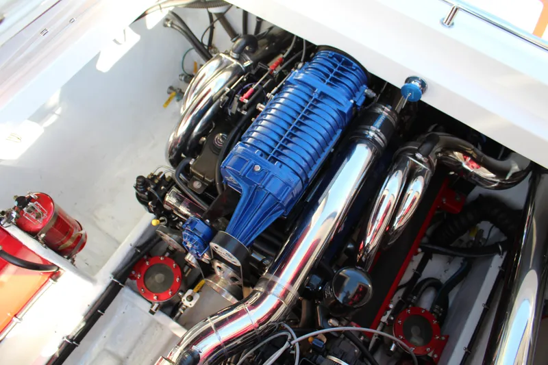 Slide: The Image of The engine compartment of a 2007 Fountain 42 Lightning with a blue engine and shiny metal parts. - 37