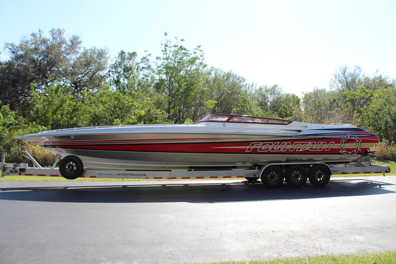 Slide: The Image of A 2007 Fountain 42 Lightning boat on a trailer, surrounded by trees and clear sky. - 4
