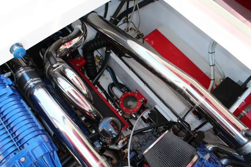 Slide: The Image of The engine compartment of a 2007 Fountain 42 Lightning with shiny metal parts and blue components. - 38