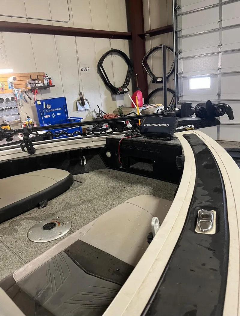 Slide: The Image of 2019 Tracker Targa V-19 Combo TE boat interior in a garage workshop. - 11
