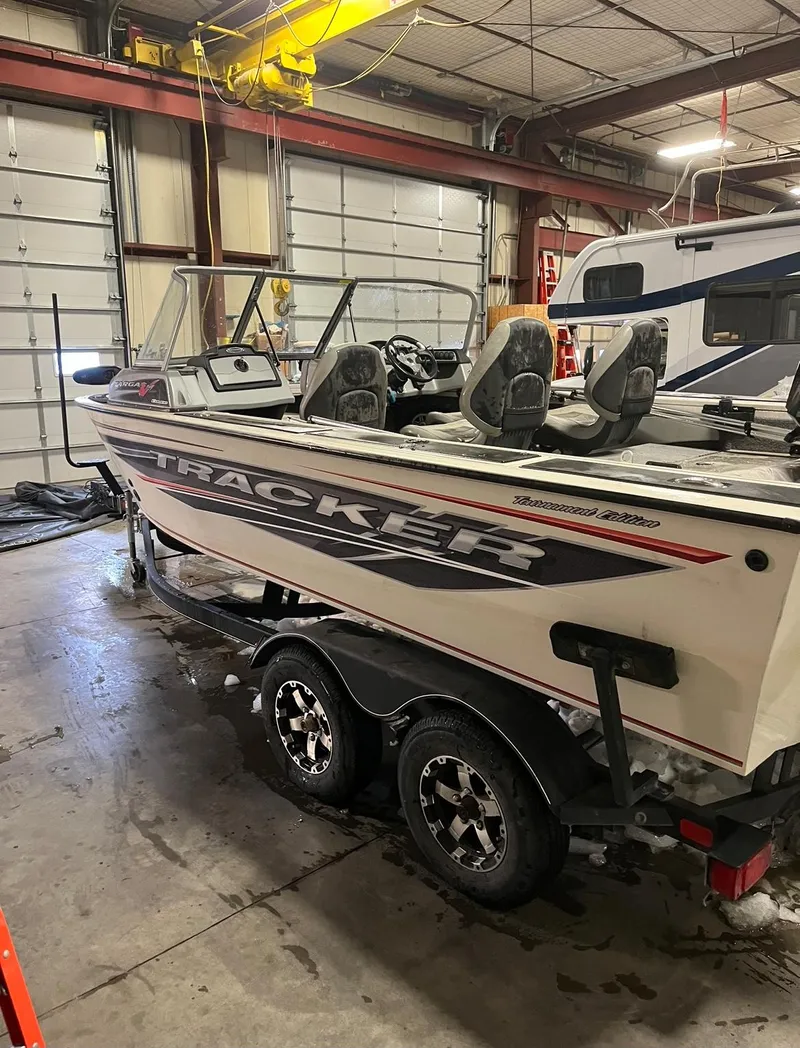 Slide: The Image of 2019 Tracker Targa V-19 Combo TE boat in a garage. - 2