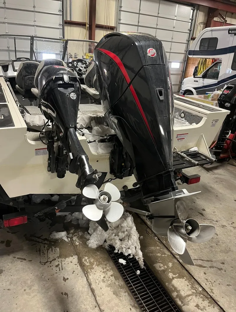 Slide: The Image of 2019 Tracker Targa V-19 Combo TE boat with dual outboard motors in a garage. - 8