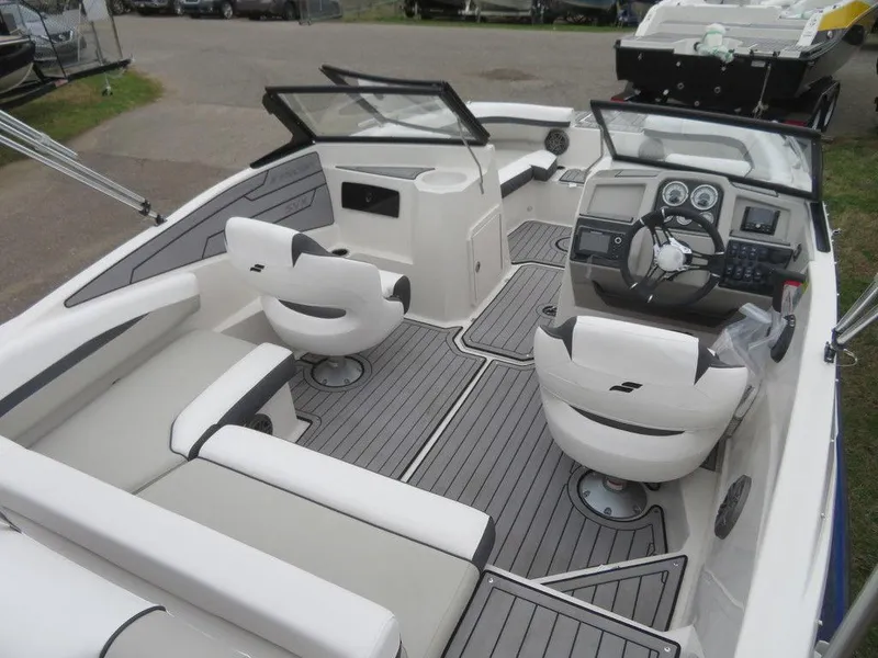 Slide: The Image of 2023 Starcraft SVX IO 210 boat interior with modern seating and dashboard. - 10